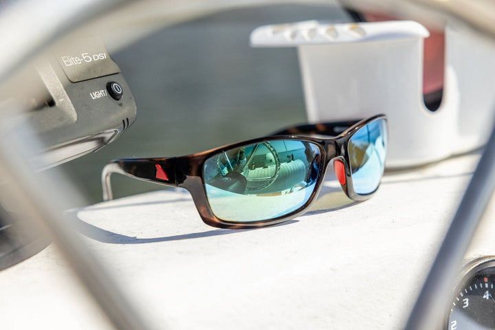 RedFin Polarized Outer Banks fishing sunglasses with matte honey drift frames and amber-green polarized lenses.