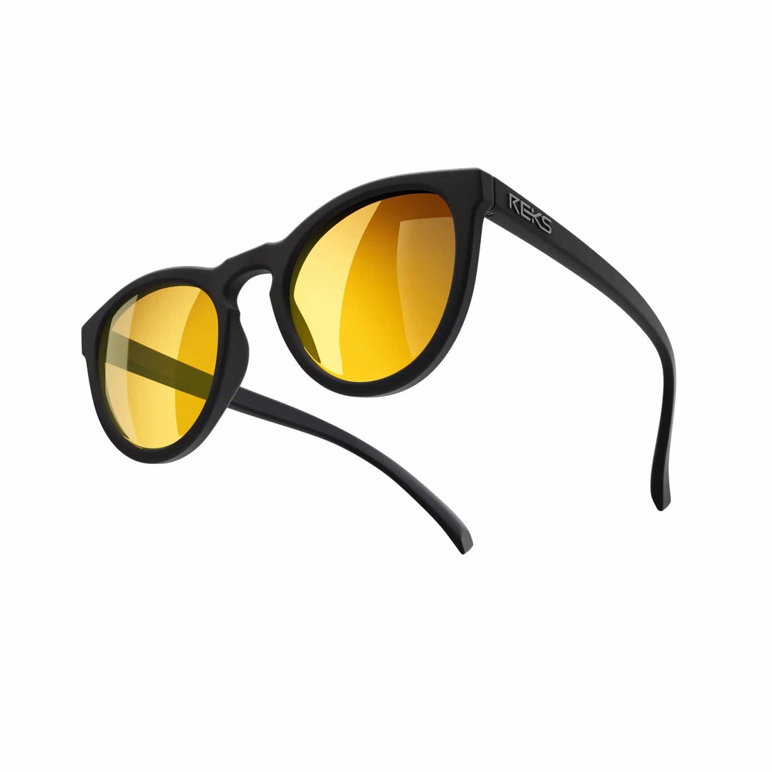 REKS® round polarized polycarbonate sunglasses with rose amber lenses, featuring a stylish round frame and UV protection.