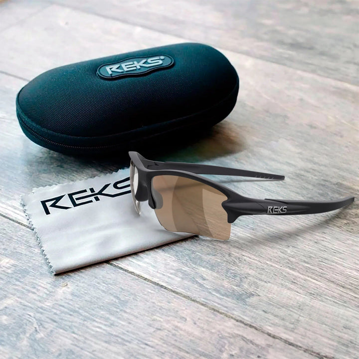 REKS Sling Blade polarized sunglasses with Trivex lenses, black frame, and adjustable nose pads, displayed in a protective case