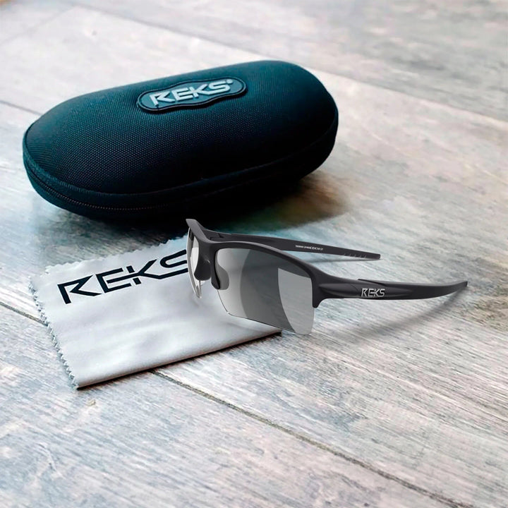 REKS Sling XM polarized sunglasses with Trivex lenses in a sleek case, featuring silver frame and black arms.