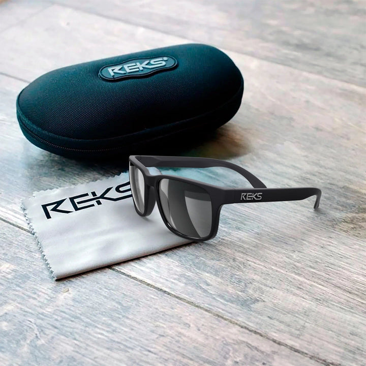 REKS® sport polarized polycarbonate prescription sunglasses in black case with blue accents, showing sleek frame and polarized lenses.