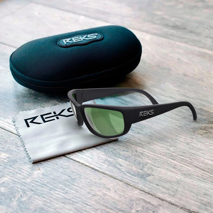 Large REKS® wrap prescription polarized polycarbonate sunglasses with black frame and tinted lenses, in protective case.