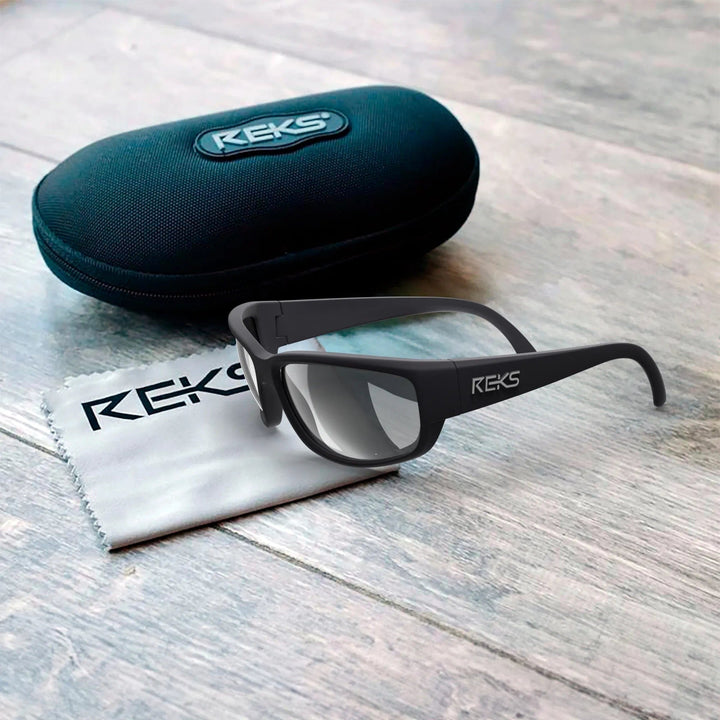 Large REKS® prescription polarized wrap sunglasses with polycarbonate lenses in a protective case, showcasing their sleek design.