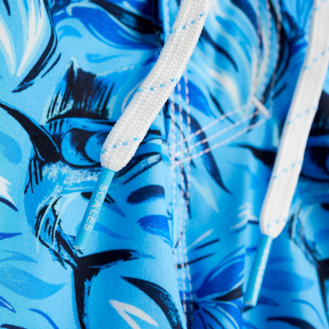 Powder blue Flower Strike First Mates boardshorts by Scalesgear.com with floral and nautical design, displayed on a hanger.