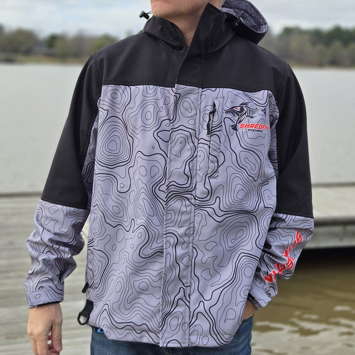 ShredFin Storm Shredder all-weather jacket with Contourz pattern, featuring waterproof fabric, adjustable hood, and multiple pockets.