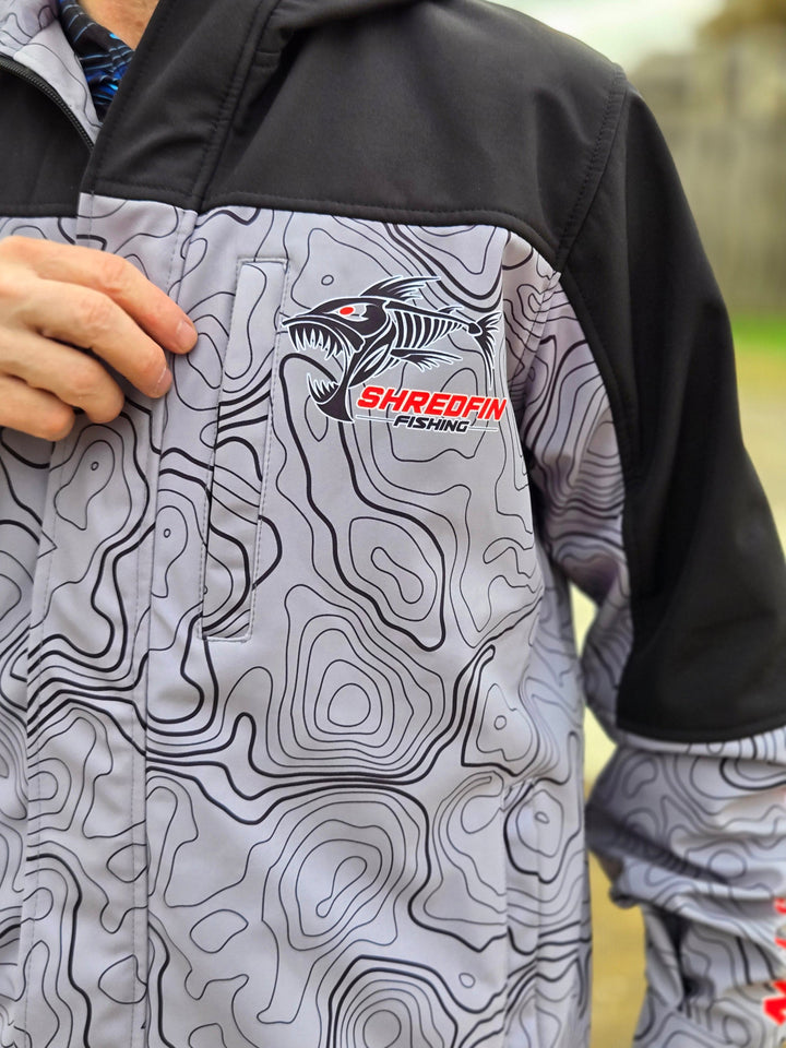 ShredFin Storm Shredder all-weather jacket with Contourz pattern, featuring a waterproof design, hood, and adjustable cuffs.