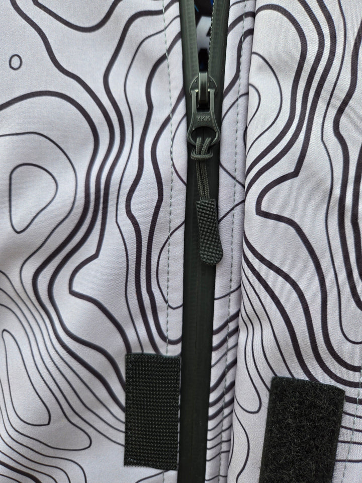 ShredFin Storm Shredder all-weather jacket with Contourz pattern, shown in a close-up of the jacket's textured fabric and design.