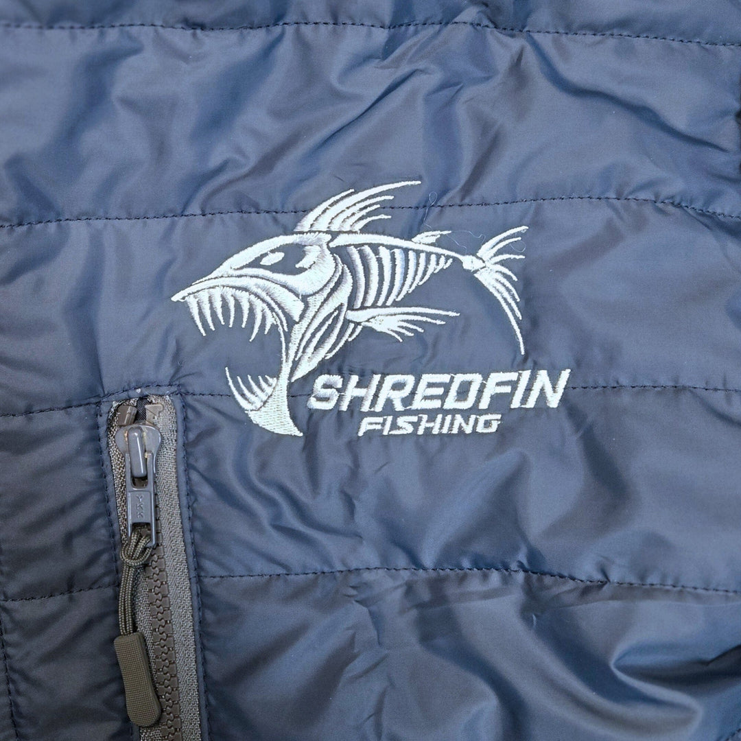ShredFin Tailwindz Navy Blue jacket displayed on a hanger, featuring a sleek design and modern style.
