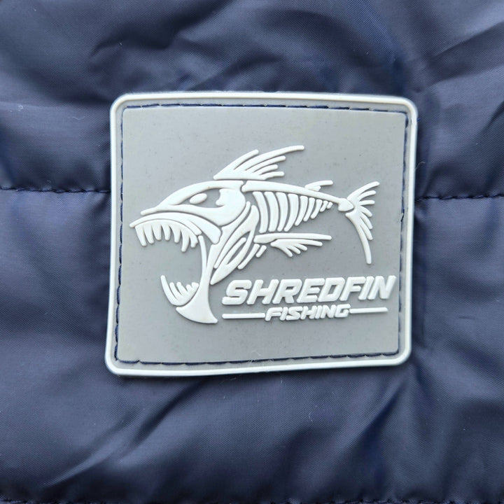 ShredFin Tailwindz Navy Blue Jacket displayed on a hanger, showcasing its sleek design and lightweight fabric.