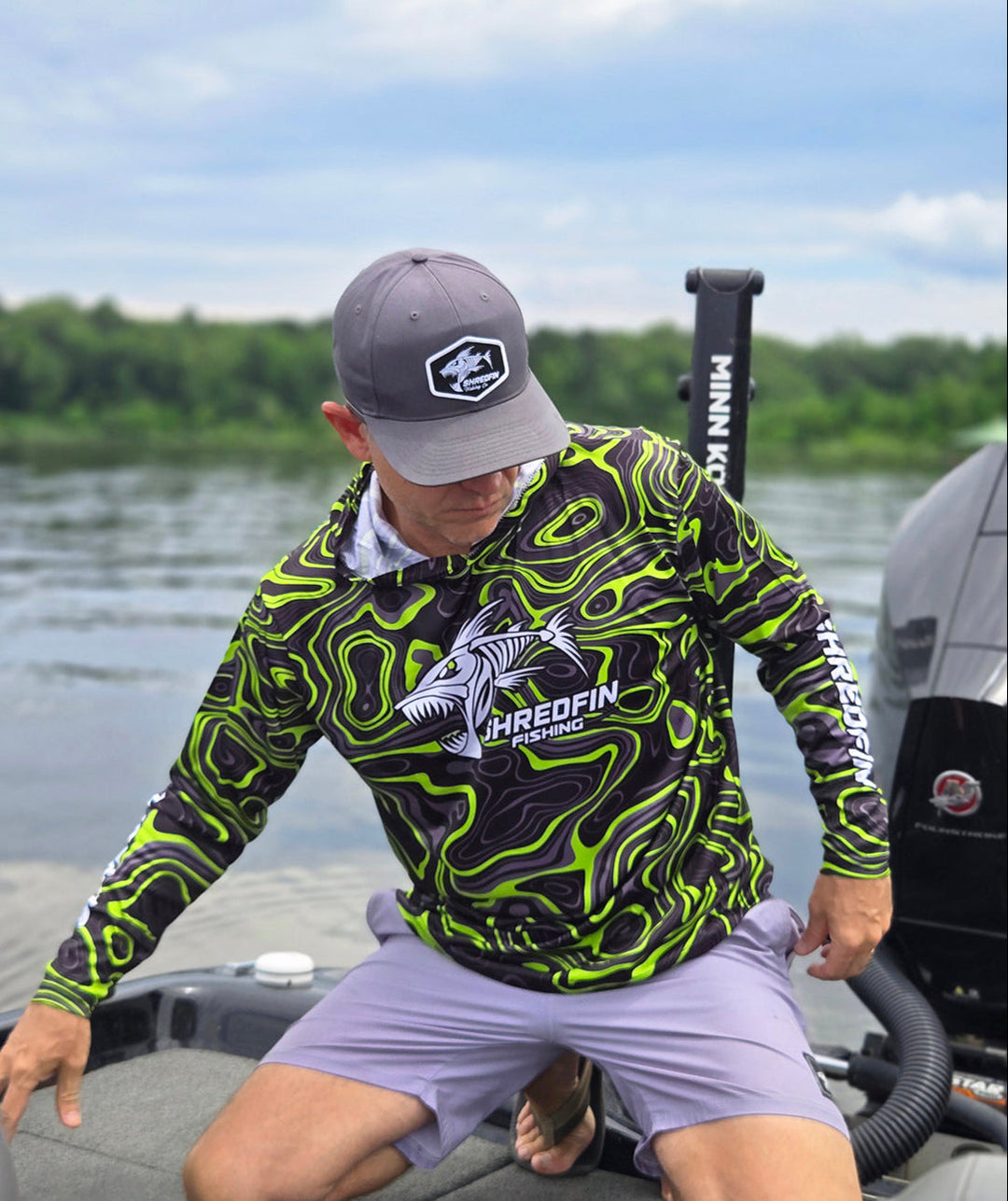 ShredFin Contourz Hooded Performance Shirt in green, featuring a fitted design and performance fabric, displayed on a model.
