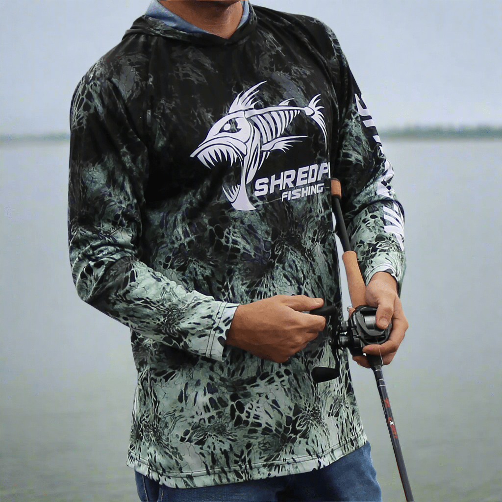 ShredFin Prym1 Camo Hooded Performance Shirt in Typhoon color, featuring camouflage pattern and athletic fit.