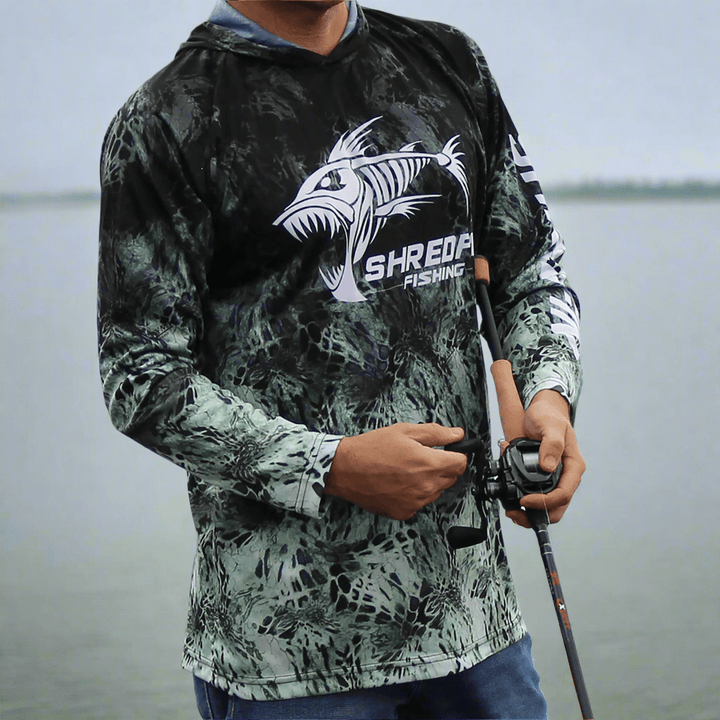 ShredFin Prym1 Camo Hooded Performance Shirt in Typhoon color, featuring camouflage pattern and athletic fit.