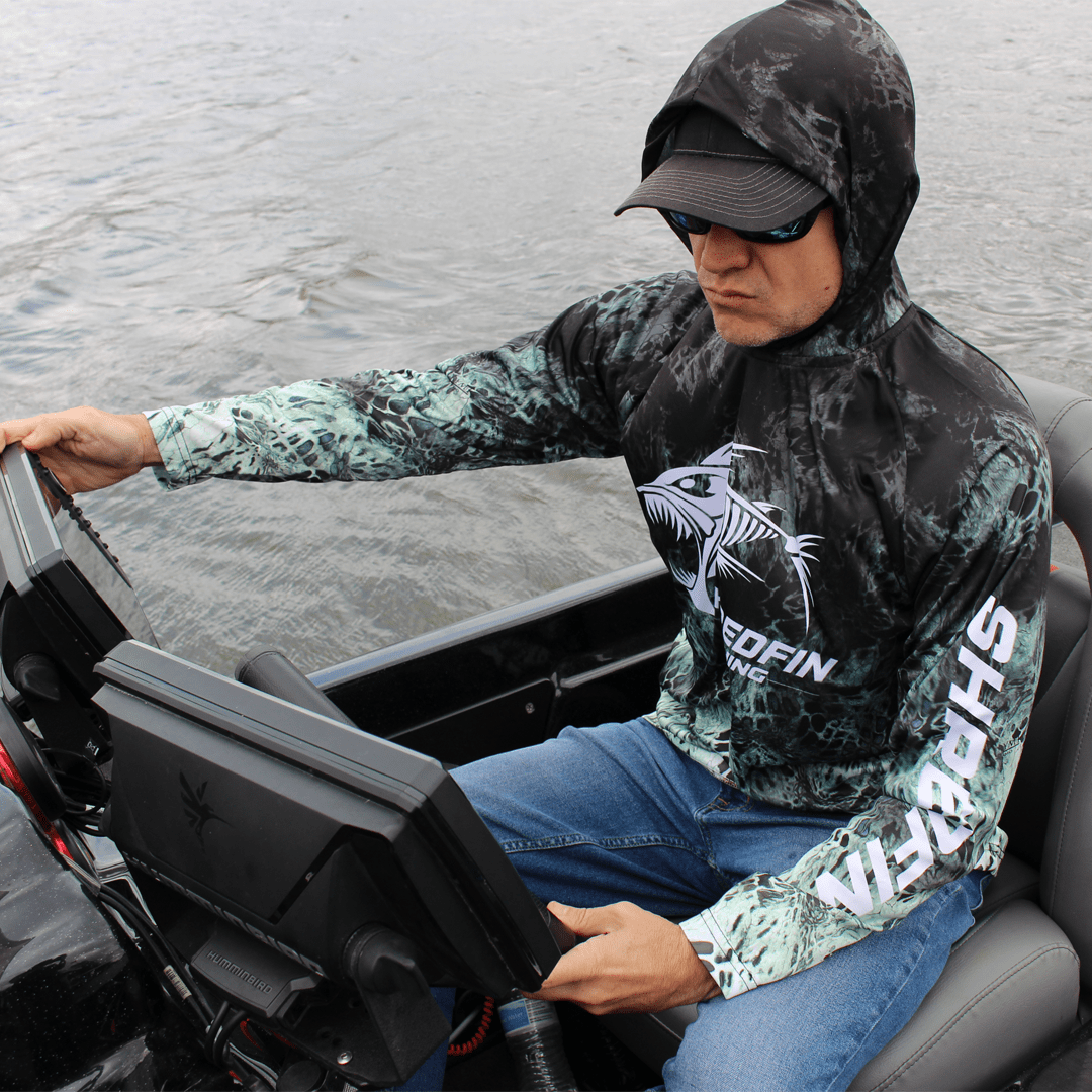ShredFin Prym1 Typhoon hooded performance shirt with camouflage design, lightweight fabric, and athletic fit.