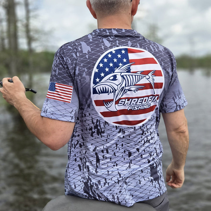 ShredFin Splash Camo Freedom short sleeve performance shirt with circle logo in tungsten gray fade, featuring camo pattern and athletic fit.