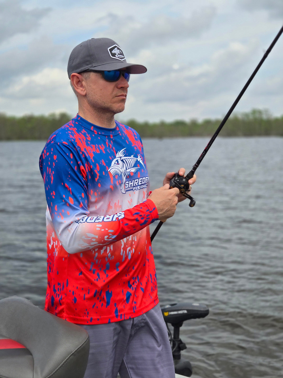 ShredFin Splash Camo Performance Shirt in Freedom Fade with moisture-wicking fabric and athletic fit, displayed on a hanger.