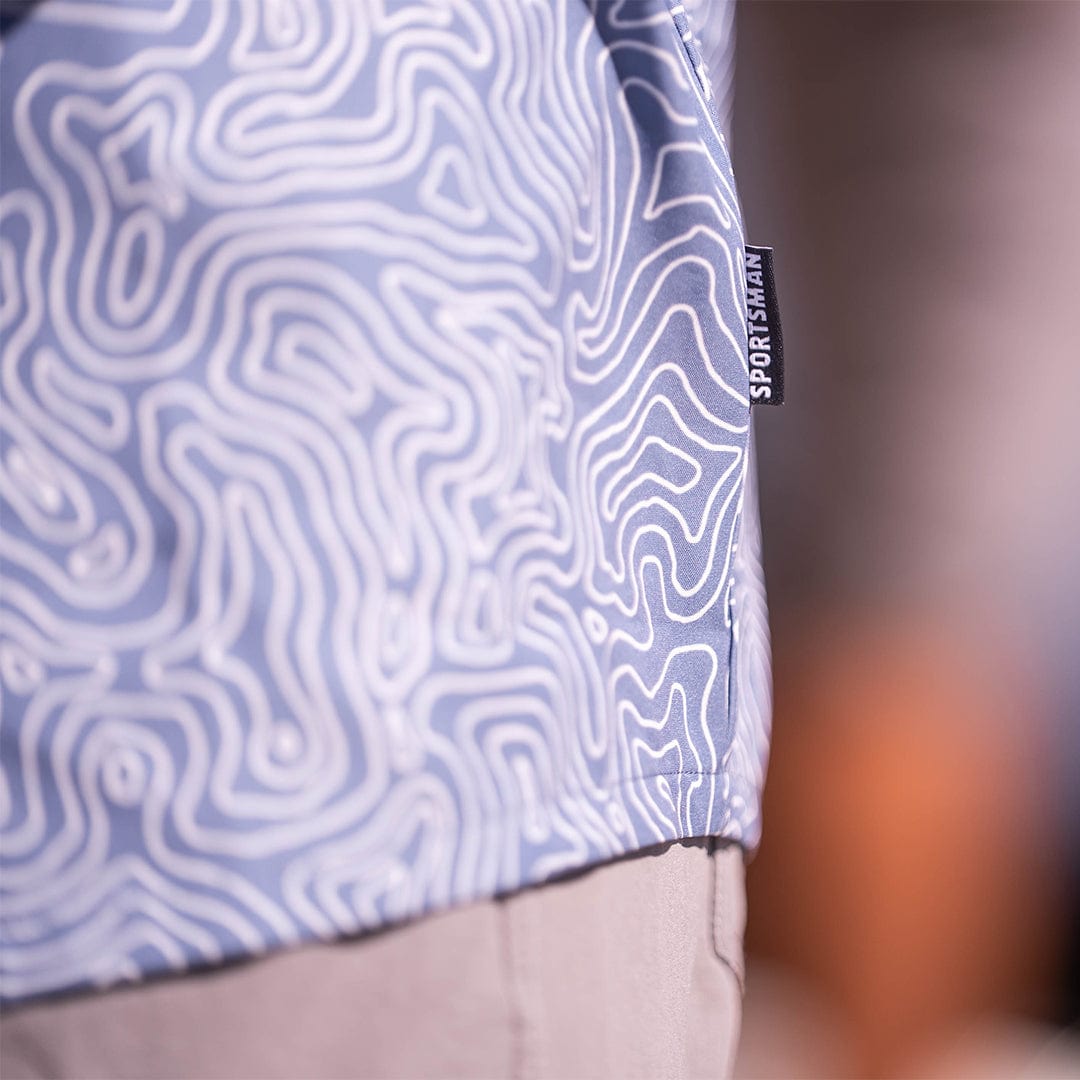 Old-school Fly Shirt by Sportsman Gear, featuring classic design and durable fabric, displayed on a hanger.