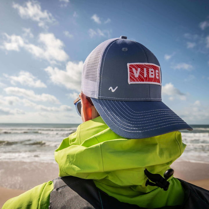 Youth size Vibe Trucker Hat by Vibe Kayaks, featuring a mesh back and adjustable strap, casual outdoor apparel.