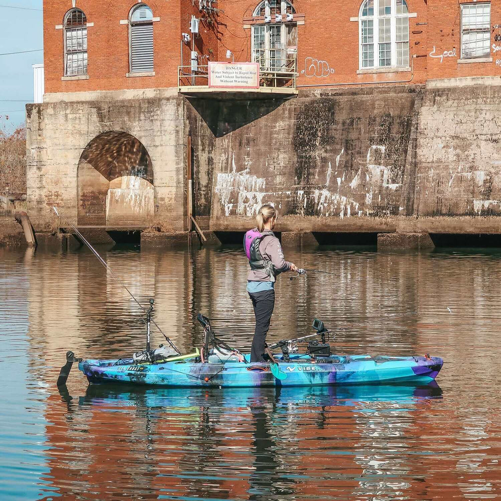 Vibe Kayaks Sea Ghost 110 kayak in blue with seating area and paddle, designed for recreational kayaking.